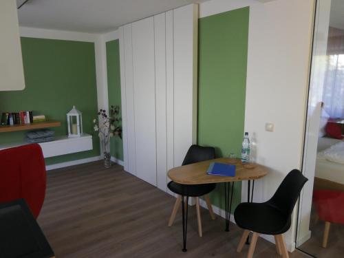 a room with a table and chairs and a bed at Fewo Blick zum Stern in Wermsdorf