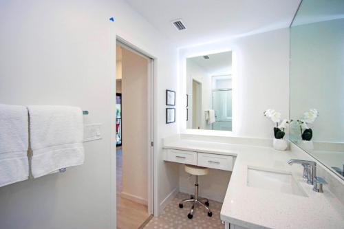 a white bathroom with a sink and a mirror at Breathtaking Gulf Views Sandalfoot Condo Sanibel Island 3A3 in Sanibel