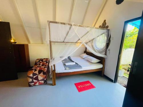 a small bedroom with a bed and a window at stargate villa in Matara
