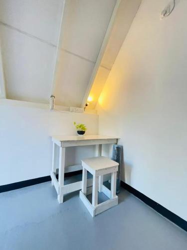 a white table and stool in a room at stargate villa in Matara
