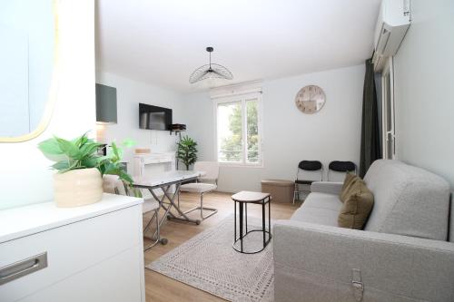 un salon avec un canapé et une table dans l'établissement Le Mistral - Calme et Climatisé - Hypercentre - Terrasse - Wifi, à Avignon