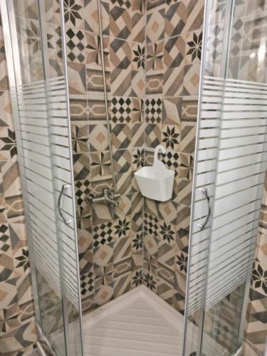 a bathroom with a shower with a toilet and a sink at Studios Paleokastritsa - Sun's Gift in Paleokastritsa
