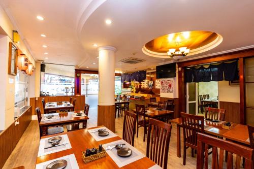 a dining room with wooden tables and chairs at Hoang Ha Boutique Hotel in Ho Chi Minh City