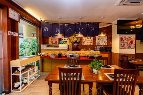 a restaurant with a table and chairs in a room at Hoang Ha Boutique Hotel in Ho Chi Minh City