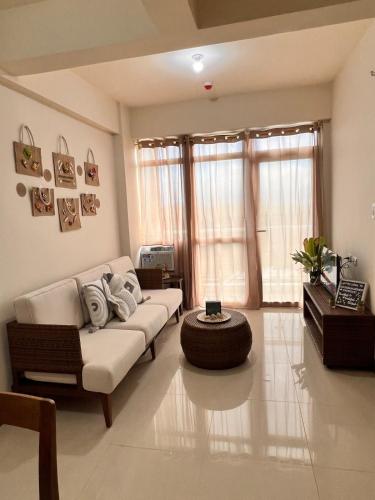 a living room with a couch and a table at A tranquil ocean view condo, private beach in Boracay