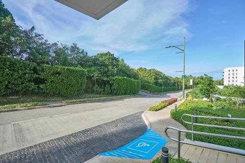 an empty street with a blue sign on the road at A tranquil ocean view condo, private beach in Boracay