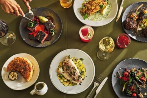 a table full of plates of food on a table at Regent Santa Monica Beach in Los Angeles