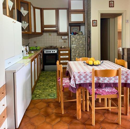 a kitchen with a table with a tablecloth on it at La Perla Marina - Furnari in Torre Forte