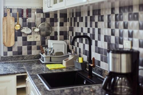 a kitchen with a sink and a counter top at MH - Upper Floor Apart in Douala