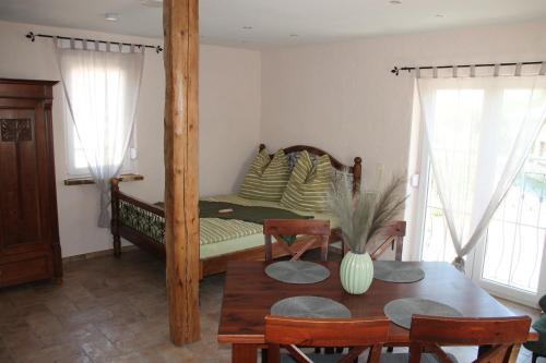 a bedroom with a bed with a table and chairs at Casa No7- primo piano in Großheringen