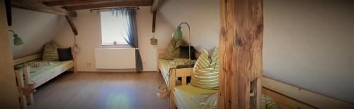 an attic room with two beds and a window at Casa No7- primo piano in Großheringen