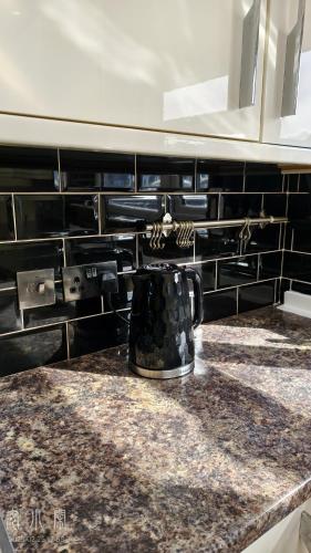 a coffee pot on a counter in a kitchen at 4 Bedroom House with Garden & Parking in Ruislip in South Ruislip Station