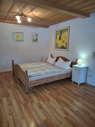 a bedroom with a large bed and a wooden floor at Beim Grafen in Frasdorf