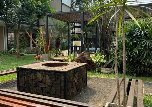 a garden with a fire pit in a park at INGA by DOT Suites in Puerto Iguazú