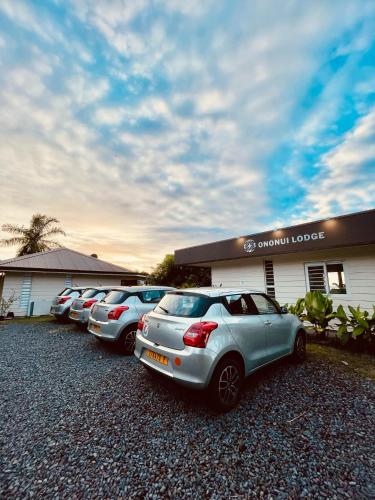 a row of cars parked in front of a building at Ononui Airport Studio in Faaa