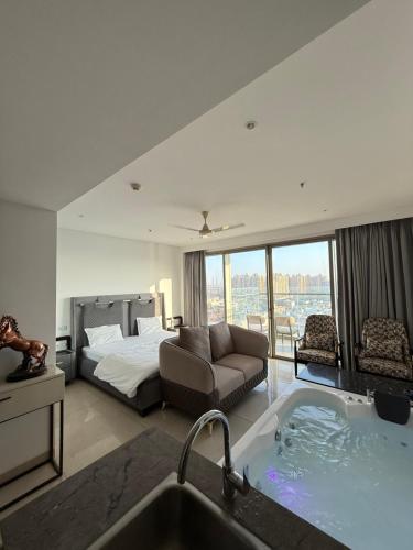 a bathroom with a tub and a bedroom with a bed at Luxe jacuzzi studio key 2 in Gurgaon