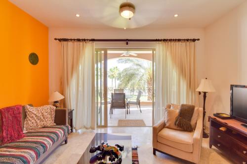 a living room with a couch and a tv at Colorful Paraiso del Mar Resort Condo with Patio! in La Paz
