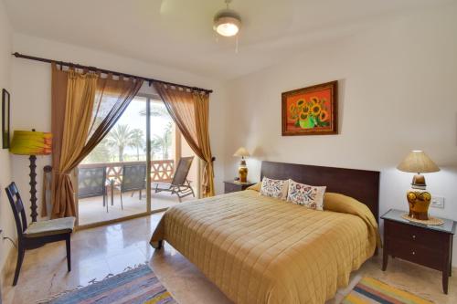 a bedroom with a bed and a balcony at Colorful Paraiso del Mar Resort Condo with Patio! in La Paz