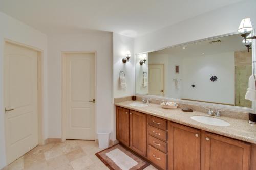 a bathroom with two sinks and a large mirror at Colorful Paraiso del Mar Resort Condo with Patio! in La Paz