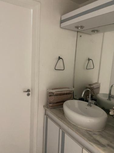 un baño con lavabo y espejo en Rio Vermelho, en Salvador