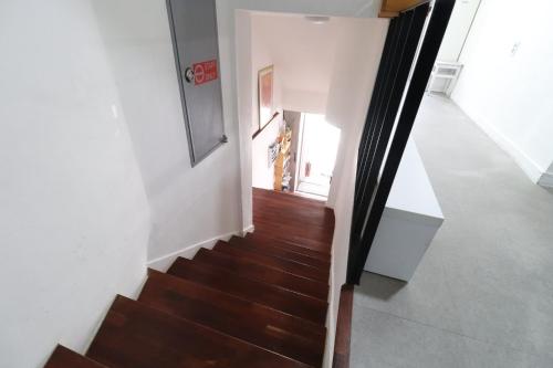 a staircase in a house with wooden floors and white walls at HAH Guesthouse in Seoul