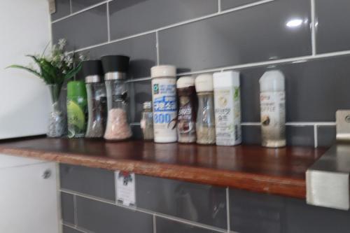 a shelf with a bunch of bottles on it at HAH Guesthouse in Seoul