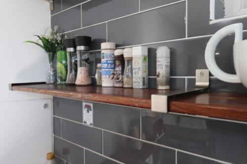 a shelf in a kitchen with products on it at HAH Guesthouse in Seoul