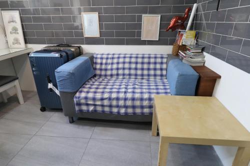 a living room with a couch and a table at HAH Guesthouse in Seoul