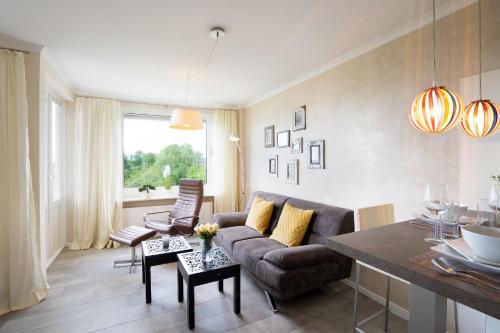 a living room with a couch and a table at Deluxe Quartier am Plöner See - Hallenbad kostenlos in Plön
