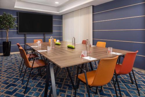 a conference room with a large wooden table and chairs at NH Collection Madrid Colón in Madrid