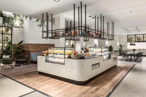 a restaurant with a counter with food on it at NH City Centre Amsterdam in Amsterdam
