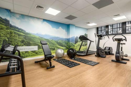 a gym with treadmills and exercise equipment in a room at NH City Centre Amsterdam in Amsterdam