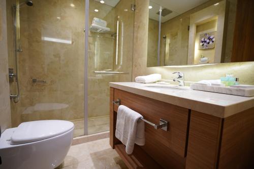 a bathroom with a toilet and a sink and a shower at Heaven Prestige Hotel in Jounieh