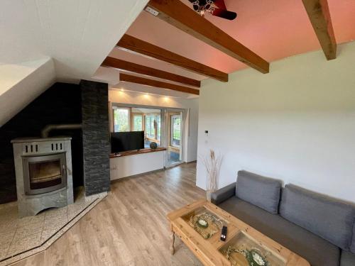 ein Wohnzimmer mit Couch und Kamin in der Unterkunft FeWo Eich im Emsland in Lingen