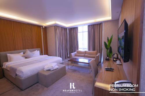 a hotel room with a large bed and a tv at Heaven Prestige Hotel in Jounieh