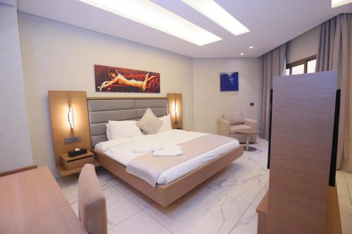 a bedroom with a large bed and a table and chairs at Heaven Prestige Hotel in Jounieh