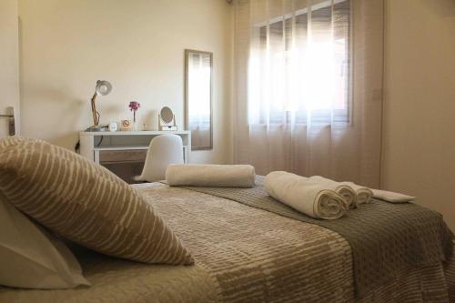 a bedroom with a bed with towels on it at Castro's guesthouse in Viana do Castelo