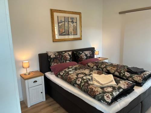 a bedroom with a large bed with a blanket at Martje in Lastrup