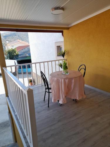 a table on a balcony with a table and chairs at Paraíso da Foz do Sabor in Torre de Moncorvo