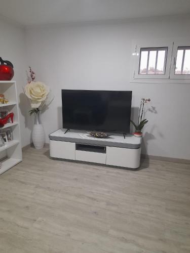 a living room with a flat screen tv on a table at Paraíso da Foz do Sabor in Torre de Moncorvo