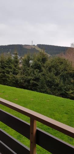 a bench sitting in front of a green field at Fewo 25 in Goslar