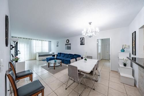 a living room with a blue couch and a table at Ocean Reserve in Sunny Isles Beach