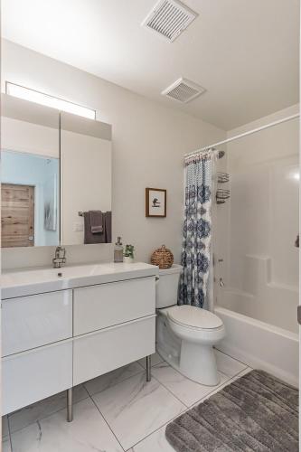 a bathroom with a sink and a toilet and a shower at Elk Rim 1140 Pine in Pine