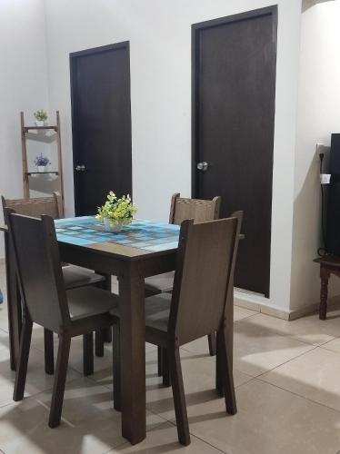 a dining room table and chairs with a blue table top at Departamento Flor de María in Ciudad Madero