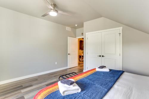 a bedroom with a bed with a blue blanket at Spacious, Rustic Spearfish Home Walk to Downtown! in Spearfish