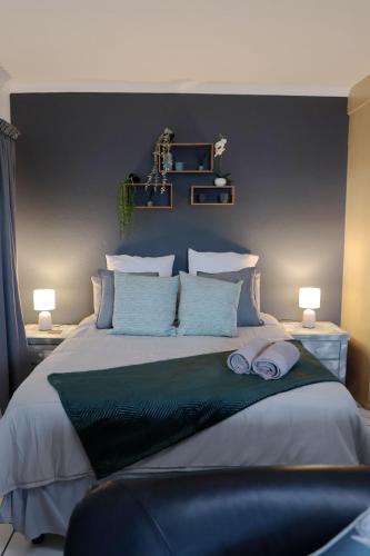 a bedroom with a large bed with two towels on it at Opal's Rest in Nelspruit