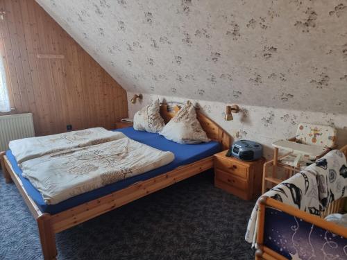 a bedroom with a wooden bed with a blue mattress at Fewo Janssen in Borkum
