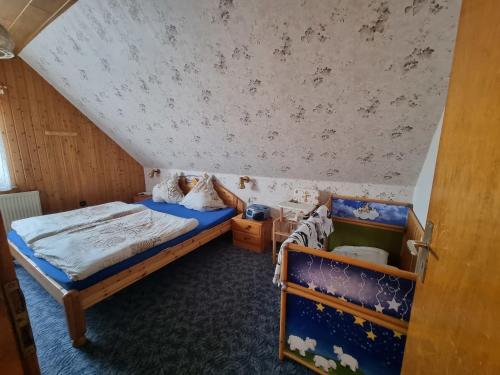 a small bedroom with a bed and a ceiling at Fewo Janssen in Borkum