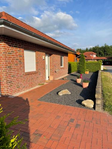 a brick house with a yard with a brick driveway at Haus Colonia in Walchum