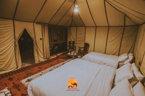 a bedroom with a bed in a tent at Trek desert Morocco Sarl in Taouz